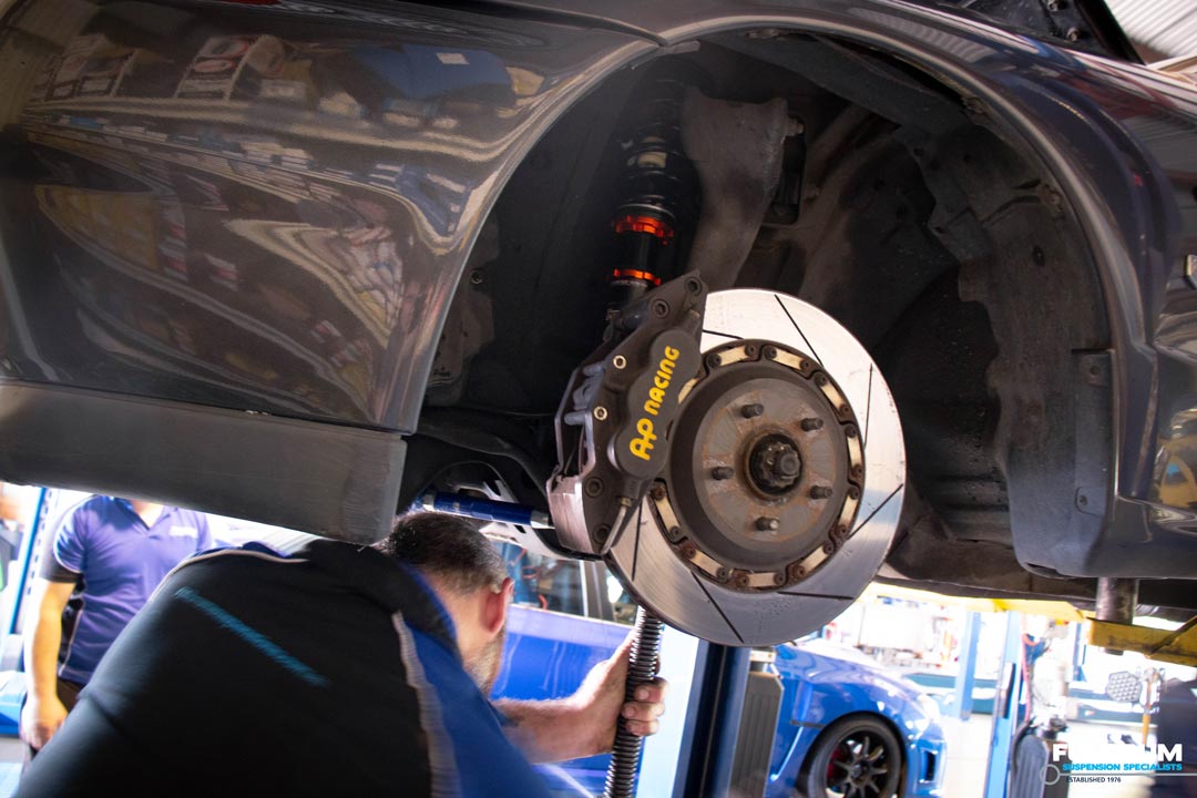 MCA Coilover being installed and inspected by fulcrum suspensions